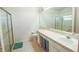 Bright bathroom with a glass-enclosed shower and a long vanity with ample countertop space at 2309 Edmonton Ct, Clermont, FL 34711