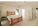 Light and airy bedroom featuring a ceiling fan, neutral carpet, and a view of the closet and bathroom at 2309 Edmonton Ct, Clermont, FL 34711