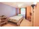 Bedroom with unique decor, a bed, and a window offering natural light and backyard views at 2309 Edmonton Ct, Clermont, FL 34711
