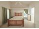 Light and airy bedroom featuring a ceiling fan, neutral carpet, and a window with backyard views at 2309 Edmonton Ct, Clermont, FL 34711