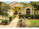 Inviting front entrance with meticulously manicured garden and pathway leading to the front door at 2309 Edmonton Ct, Clermont, FL 34711