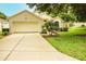 Attractive one-story home boasting a manicured lawn, driveway, and attached two-car garage at 2309 Edmonton Ct, Clermont, FL 34711