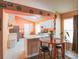 Bright kitchen featuring white cabinets, updated appliances, and a breakfast bar, ideal for everyday meals at 2309 Edmonton Ct, Clermont, FL 34711