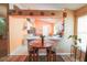 Open-concept kitchen featuring a breakfast bar, white cabinetry, and updated appliances, perfect for entertaining at 2309 Edmonton Ct, Clermont, FL 34711