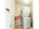 Functional laundry area equipped with a stacked washer and dryer and a convenient fold-down table at 2309 Edmonton Ct, Clermont, FL 34711
