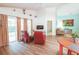 Open living room space with wood laminate floors, vaulted ceilings, and access to the screened outdoor patio at 2309 Edmonton Ct, Clermont, FL 34711