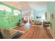 Spacious living room with vaulted ceilings, wood laminate flooring, and calming blue-green color scheme at 2309 Edmonton Ct, Clermont, FL 34711