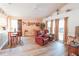 Comfortable living room with vaulted ceilings, wood laminate flooring, and a view of the outdoor space at 2309 Edmonton Ct, Clermont, FL 34711