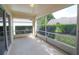 Relaxing screened-in back patio offering an outdoor space and views of the landscaped backyard at 2309 Edmonton Ct, Clermont, FL 34711