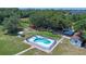 Aerial view of the property, highlighting the fenced in-ground pool and mature trees at 2500 Derby Dr, Kissimmee, FL 34744