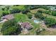 Aerial view highlights a home on a large private lot with a pool and mature landscaping at 2500 Derby Dr, Kissimmee, FL 34744