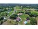 Aerial view of a home with a private pool, spacious yard, and a serene country setting at 2500 Derby Dr, Kissimmee, FL 34744