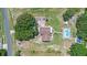 Aerial view showcases a home with large lot, mature trees, pool and plenty of parking at 2500 Derby Dr, Kissimmee, FL 34744