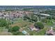 Aerial shot of home with pool, surrounded by lush greenery in a neighborhood setting at 2500 Derby Dr, Kissimmee, FL 34744