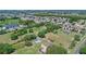 Expansive aerial view of the community with the property featuring a private pool and wooded lot at 2500 Derby Dr, Kissimmee, FL 34744