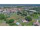 Aerial view of a home situated in a mature community with a private lot and pool at 2500 Derby Dr, Kissimmee, FL 34744