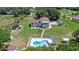 High-angle view of the home highlighting the in-ground pool, yard and driveway at 2500 Derby Dr, Kissimmee, FL 34744