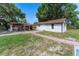 A storage building is centered between a patch of grass and a concrete walkway at 2500 Derby Dr, Kissimmee, FL 34744
