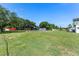 Large backyard with a pool, sheds, and an open area for outdoor enjoyment at 2500 Derby Dr, Kissimmee, FL 34744