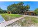 Expansive backyard with utility shed, lush green lawn, and mature trees at 2500 Derby Dr, Kissimmee, FL 34744