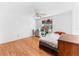 Bedroom with hard wood floors, ceiling fan, and window with decorations at 2500 Derby Dr, Kissimmee, FL 34744