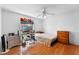 Bedroom with hard wood floors, ceiling fan, and window with decorations at 2500 Derby Dr, Kissimmee, FL 34744