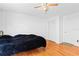 Bedroom with hardwood floors, ceiling fan, closet, and white walls at 2500 Derby Dr, Kissimmee, FL 34744
