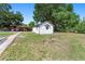 Quaint one-story home with white siding and mature trees offers a peaceful setting at 2500 Derby Dr, Kissimmee, FL 34744
