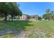 Spacious two-story home with a front porch and large yard, perfect for outdoor activities at 2500 Derby Dr, Kissimmee, FL 34744