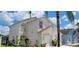 A side view of a two-story home showcasing stucco siding, well-kept landscaping, and an attached garage at 2524 Hamlet Ln, Kissimmee, FL 34746