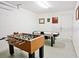 A game room is equipped with foosball and air hockey tables for recreation at 2524 Hamlet Ln, Kissimmee, FL 34746