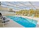 A screened-in pool area with lounge chairs and a clear blue swimming pool perfect for relaxation at 2524 Hamlet Ln, Kissimmee, FL 34746