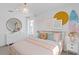 Cheerful bedroom with a surfboard wall art and bright light from windows, creating a vibrant atmosphere at 3091 Norcott Dr, Davenport, FL 33837