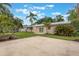 An expansive backyard with tropical landscaping, a lush green lawn, and a peaceful patio perfect for outdoor enjoyment at 3608 Eloise St, Orlando, FL 32806