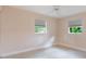 Inviting bedroom with tiled flooring, a ceiling fan, and views to the outdoors through two sunny windows at 3608 Eloise St, Orlando, FL 32806