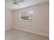 A brightly lit, empty bedroom featuring tiled flooring and a large window that provides views of the outdoors at 3608 Eloise St, Orlando, FL 32806