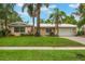 Charming single-story home featuring lush landscaping, a well-manicured lawn, and a metal roof for lasting durability at 3608 Eloise St, Orlando, FL 32806