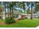 Charming home exterior featuring lush landscaping, a well-manicured lawn, mature trees, and a welcoming facade at 3608 Eloise St, Orlando, FL 32806