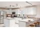 Bright kitchen with granite countertops, stainless steel appliances, white cabinets, and counter seating at 3608 Eloise St, Orlando, FL 32806
