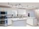 Well-equipped kitchen featuring granite countertops, white cabinetry, stainless steel appliances, and modern track lighting at 3608 Eloise St, Orlando, FL 32806