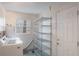 Functional laundry room featuring ample storage space, a utility sink, modern appliances, and a bright window at 3608 Eloise St, Orlando, FL 32806