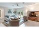 Cozy living room featuring a brick fireplace, comfortable seating, and bright French doors to the patio at 3608 Eloise St, Orlando, FL 32806