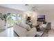 Bright living area with a brick fireplace, large windows, and cozy furniture for relaxed living at 3608 Eloise St, Orlando, FL 32806