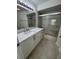 Bathroom featuring a vanity with marble countertop and shower/tub with sliding glass doors at 3621 Atrium Dr # U-4, Orlando, FL 32822