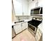 Modern kitchen with white cabinets, stainless steel appliances, and light countertops at 3621 Atrium Dr # U-4, Orlando, FL 32822