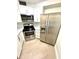 Bright kitchen with stainless steel appliances, white cabinetry, and light hardwood floors at 3621 Atrium Dr # U-4, Orlando, FL 32822