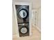 Laundry room includes a black stacked washer and dryer unit with white trim at 3621 Atrium Dr # U-4, Orlando, FL 32822