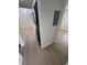 Hallway view of stacked black washer and dryer next to a white electrical panel box at 3621 Atrium Dr # U-4, Orlando, FL 32822