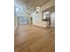 Open living room with vaulted ceilings, fan, sliding doors, and wood-look flooring at 3621 Atrium Dr # U-4, Orlando, FL 32822