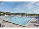 Large swimming pools with lounge chairs and a view of the lake at 3621 Atrium Dr # U-4, Orlando, FL 32822